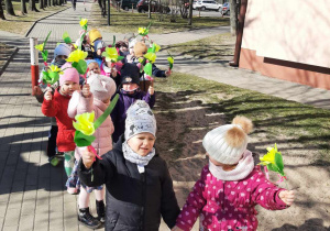 Dzieci idące w przemarszu z okazji Pierwszego Dnia Wiosny.